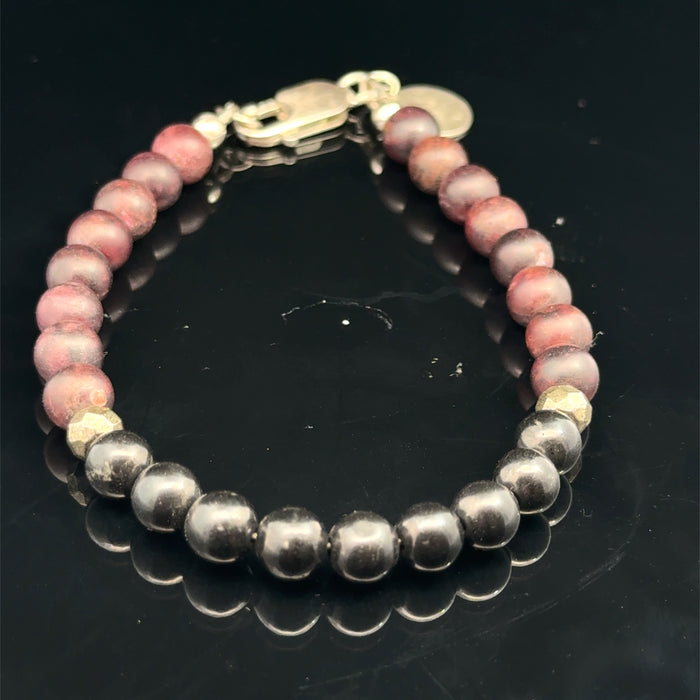 Red Garnet, Shungite, and Pyrite gemstone beaded bracelet with a sterling silver lobster claw on a black background, front overview.