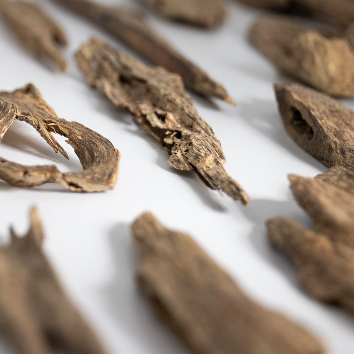 Macro view of natural agarwood chips with varied shapes and wood grain