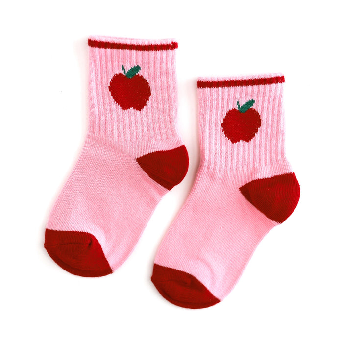 pink crew socks with red trim and red apple design at the ankle for back to school