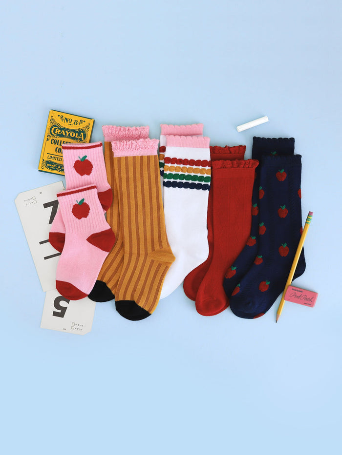 flat lay of girls' back to school pattern crew and knee socks