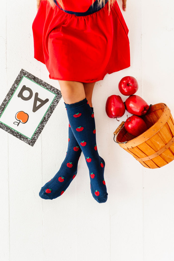girl wearing navy apple knee high socks