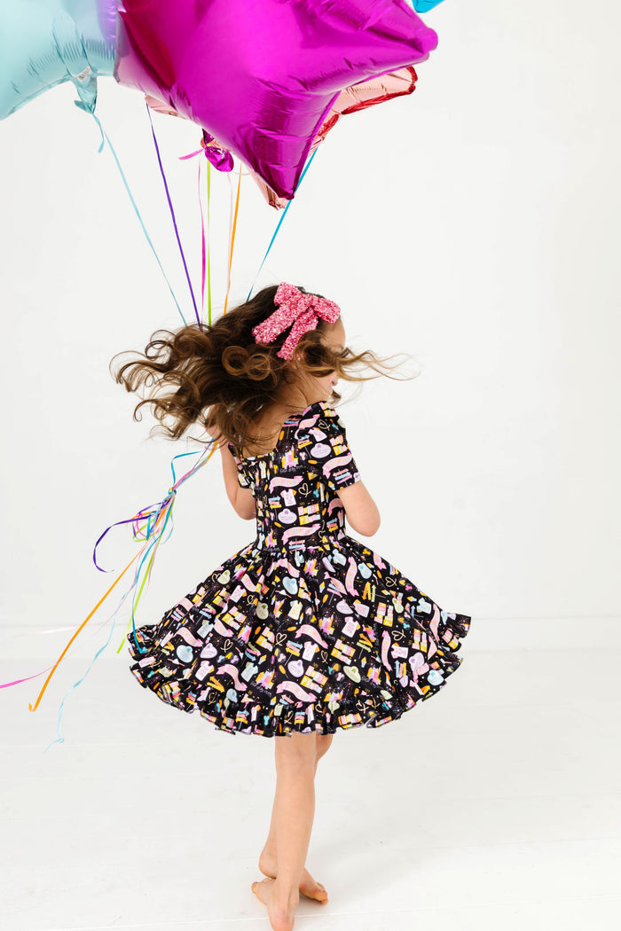 girl twirling in black best day ever print short sleeve mod twirl dress with star balloons