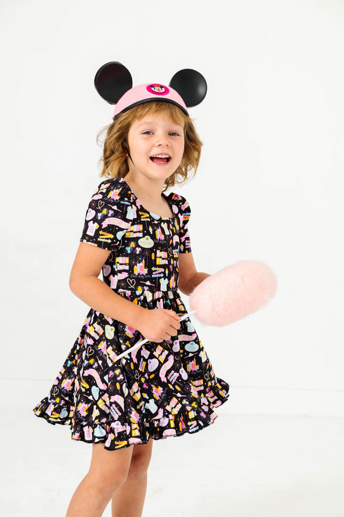 little girl holding cotton candy with vintage minnie mouse ears and black best day ever short sleeve twirl dress