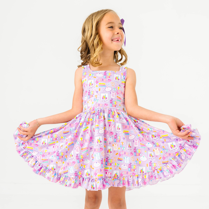 young girl in sleeveless square neck twirl dress with purple best day ever print for the happiest place on earth