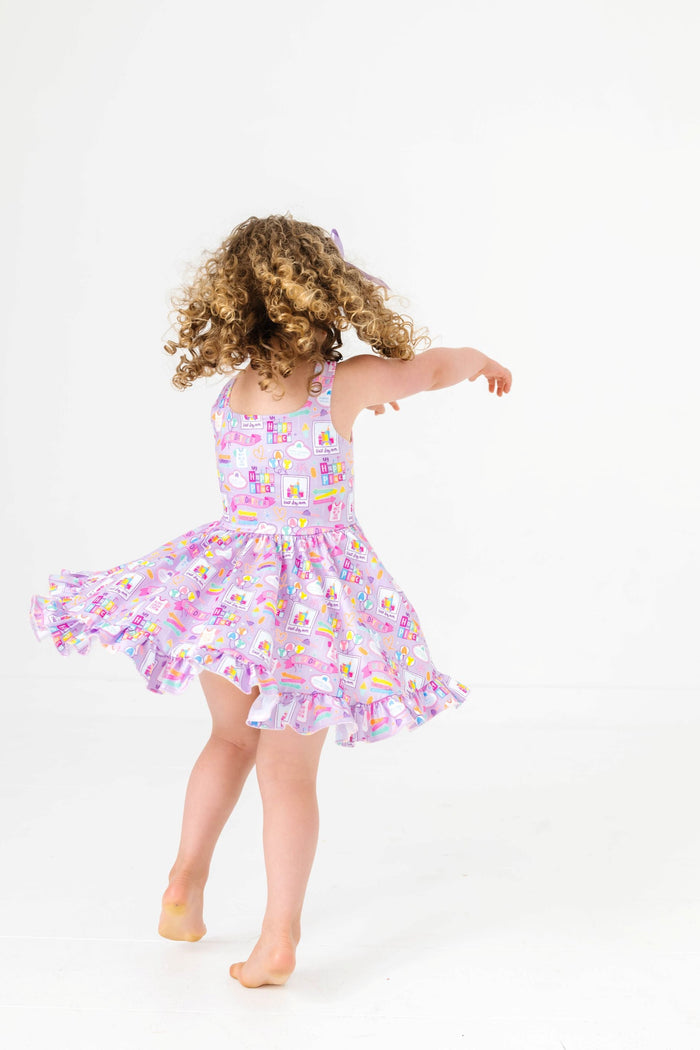 little girl twirling in purple sleeveless best day ever twirl dress