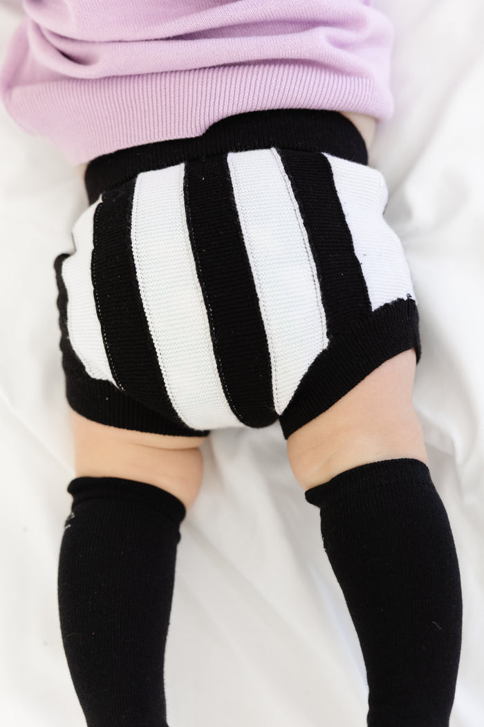 back view of baby in black and white striped 100% cotton knit bloomers for Halloween