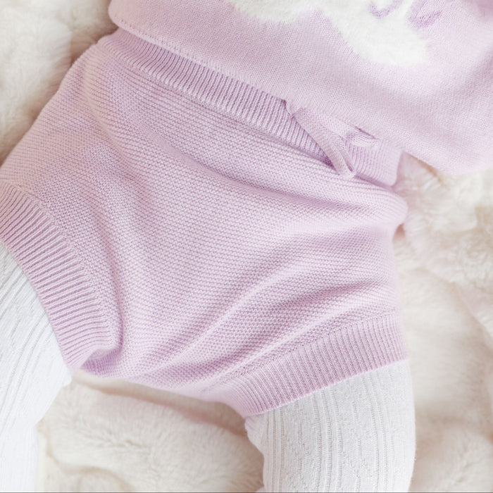 closeup of lilac cotton knit bloomers on baby girl paired with matching bunny pullover sweater and white cable knit tights for easter