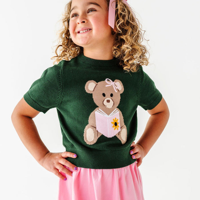 girl wearing forest green sweater tee with reading bear design for back to school