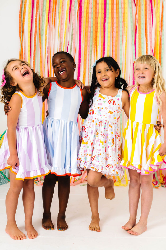 girls in coordinating wide striped twirl dresses with contrast binding to match circus themed dress