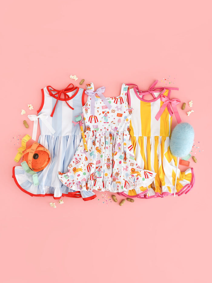 girls' circus print sleeveless twirl dress paired with two wide striped tank twirls for summer carnival and fair trips