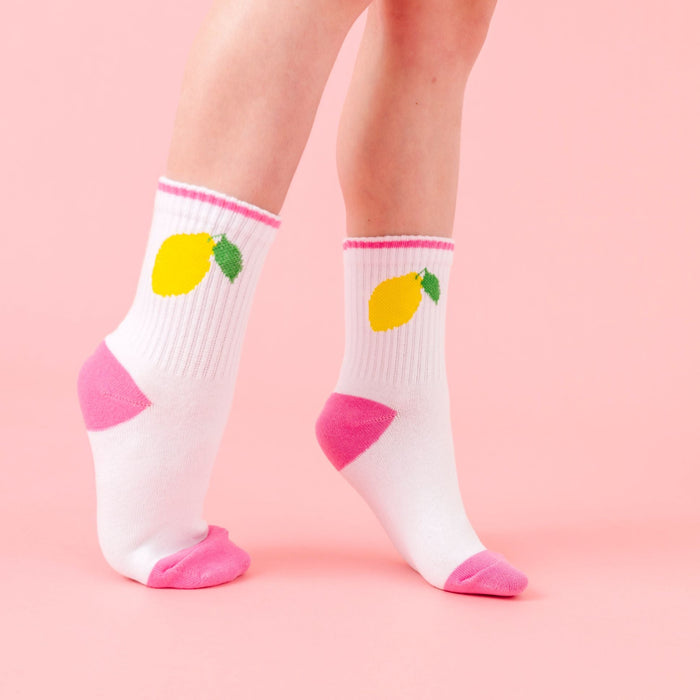 closeup of white crew socks with pink trim and yellow lemon design from fruity sock 3-pack