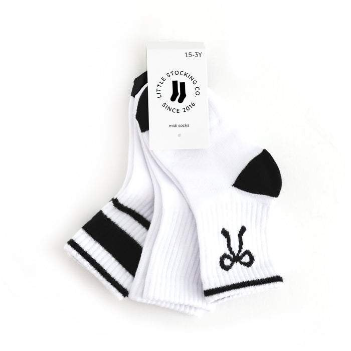 tagged three pack of girl's crew socks with designs in black and white
