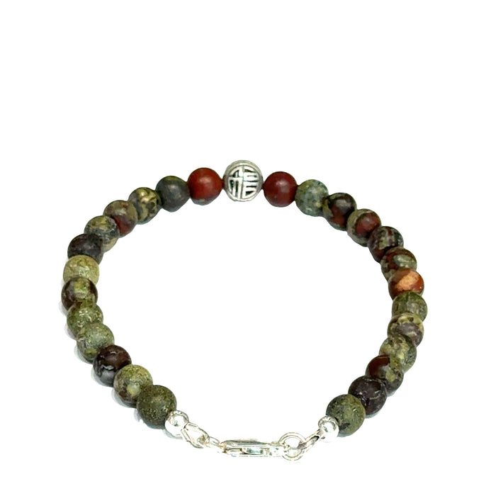 Dragon Blood Jasper gemstone beaded bracelet with sterling silver pattern bead and a lobster claw clasp showing red and green natural patterns  on a white background, back view.