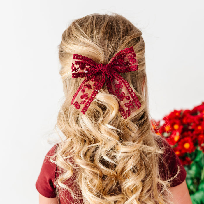 girl in burgundy fall dress and matching lace burgundy hair bow on clip