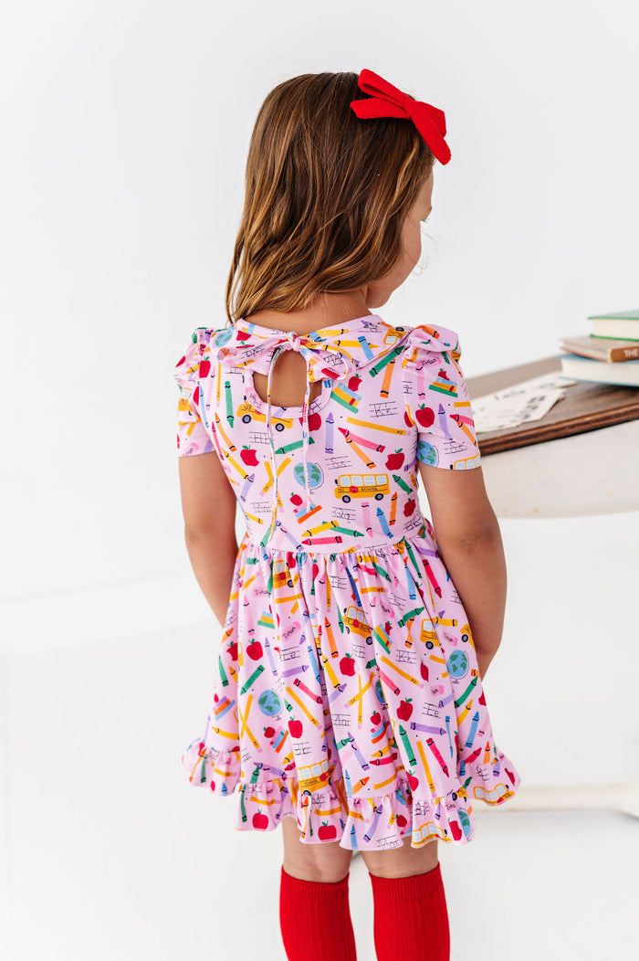Pink back to school print dress with bow tie back and ruffle twirl skirt