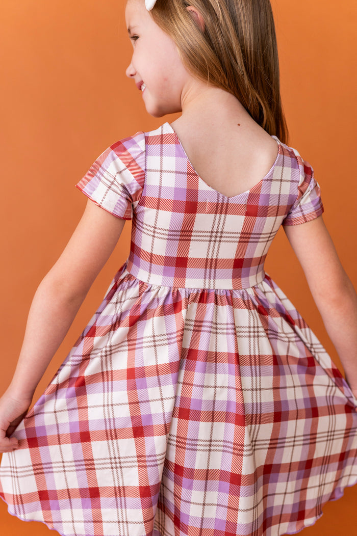 back view little girl v-neck twirl dress in ivory plaid for fall