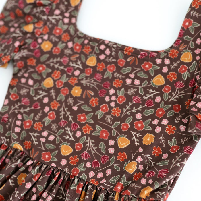 closeup of twirl dress bodice with floral pattern in shades of brown, rust, rose and mustard