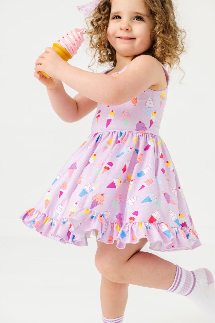 little girl twirling with ice cream cone in ice cream print tank twirl dress and matching lavender stripe crew socks and lace bow