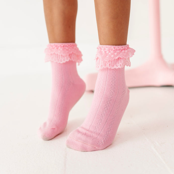 girl on tip toes in lace trimmed pink ankle socks