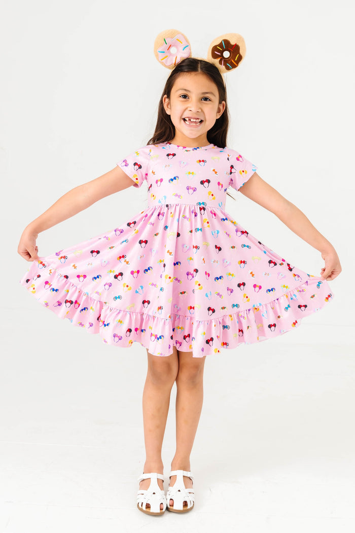 little girl wearing pink magical ears dress with fuzzy donut mickey ears