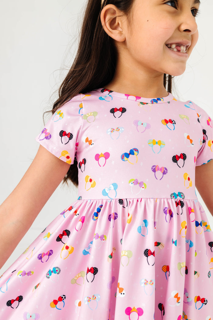 little girl wearing pink magical ears dress