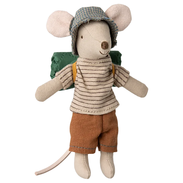 A toy mouse dressed in a striped shirt, brown pants, and a green backpack, wearing a hat with thin stripes.