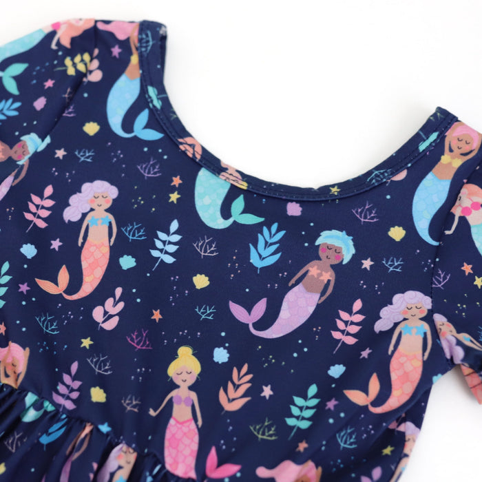 Navy blue dress with colorful mermaid pattern on a white background