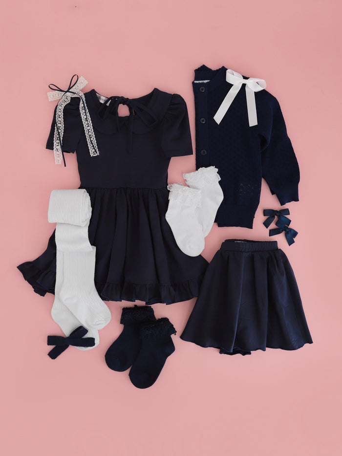 girls' uniform dress, skort, sweater, socks and bows in navy and white for back to school