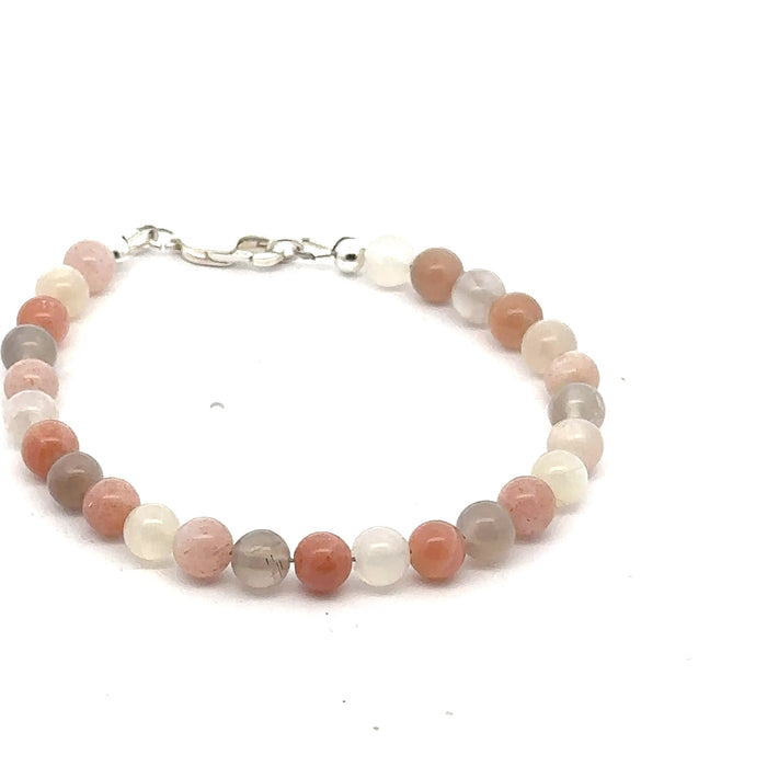 A mix Moonstone gemstone beaded bracelet with a sterling silver lobster claw clasp on a white background, front, overview.