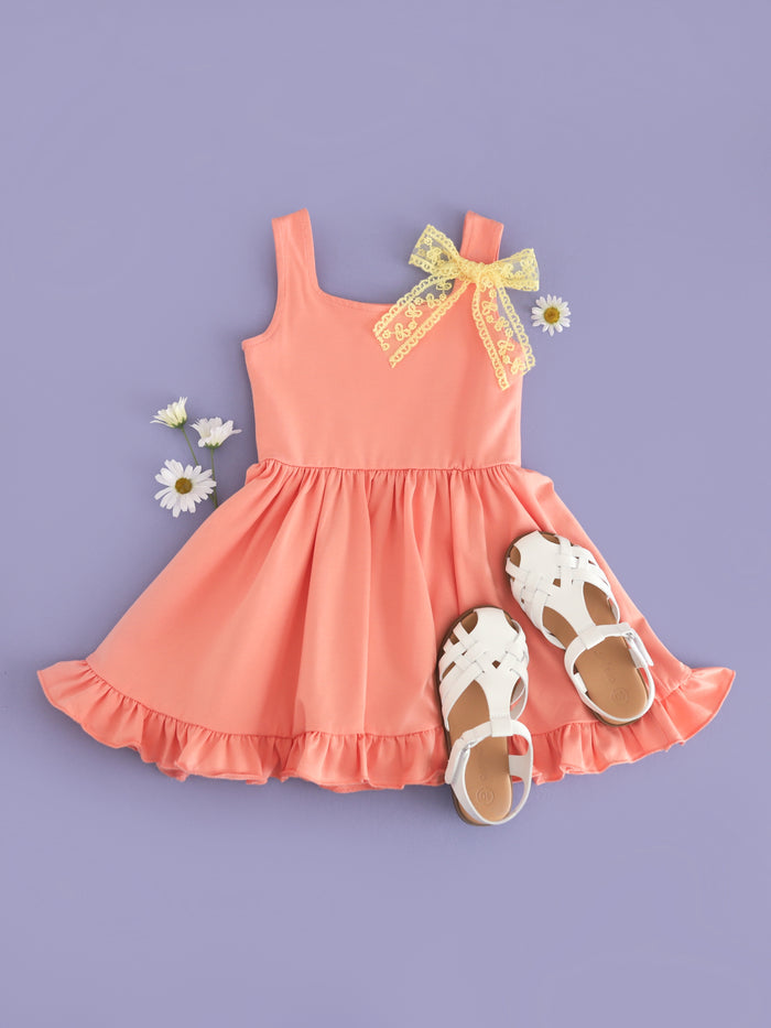 girls summer peach cotton blend sleeveless twirl dress paired with white sandals and yellow lace hair bow on clip