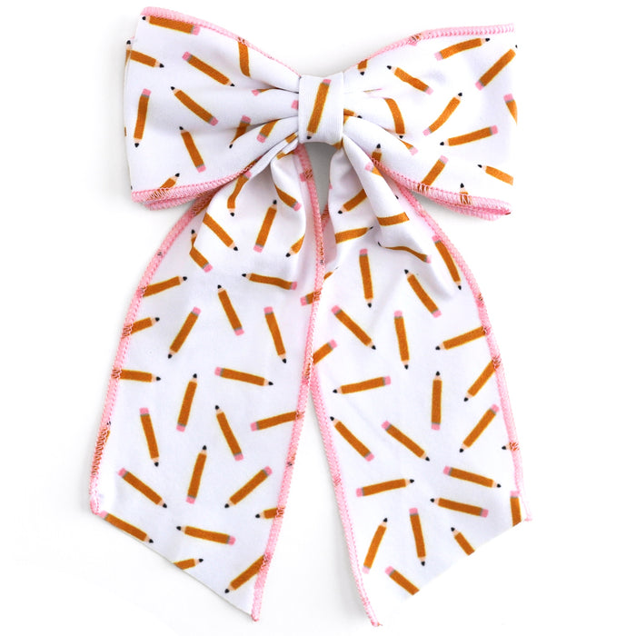 girls' white oversized hair bow with pencil print and pink trim for back to school