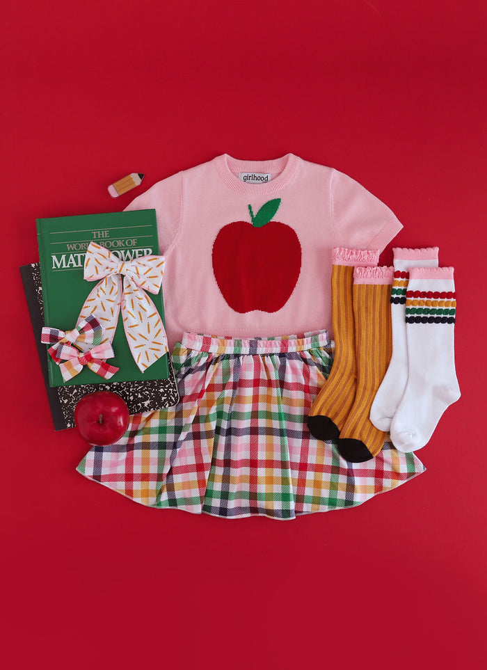 first day of school outfit for girls pink apple sweater with rainbow plaid skirt and matching bows and socks