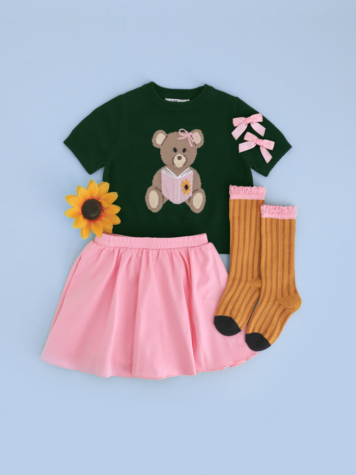 girls' back to school short sleeve green sweater with teddy bear design paired with matching pink skort, pigtail clips and pencil knee highs