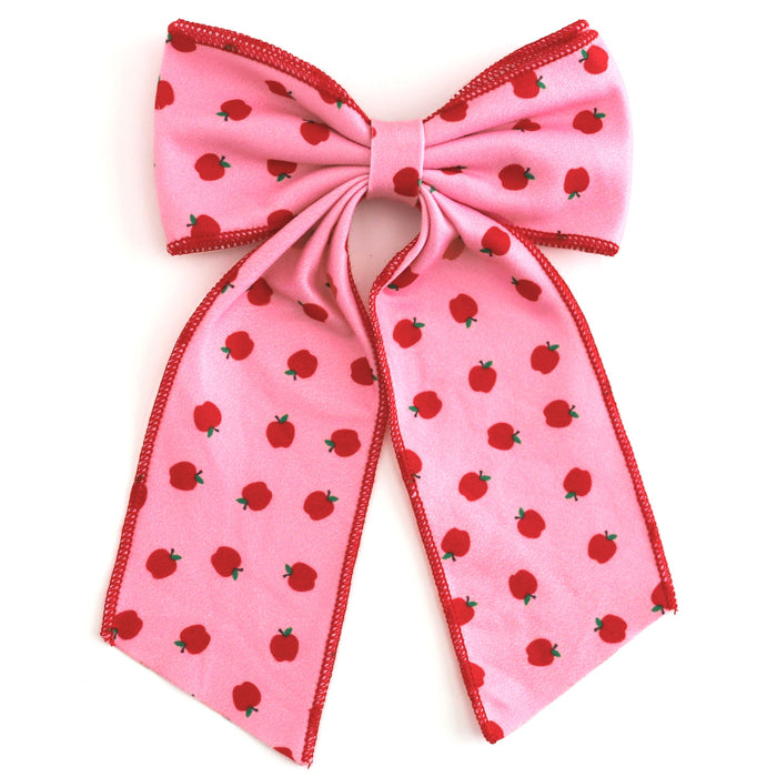 girls' pink oversized double hair bow with red apple print and red trim to match back to school apple print dress