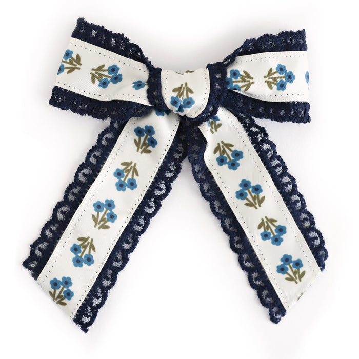 girls' blue floral hair bow with navy lace trim on alligator clip