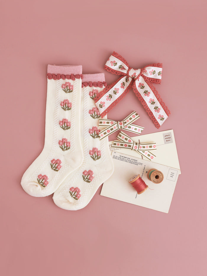 girls old rose floral print coordinates on knee socks, pigtail bows and ribbon hair bow