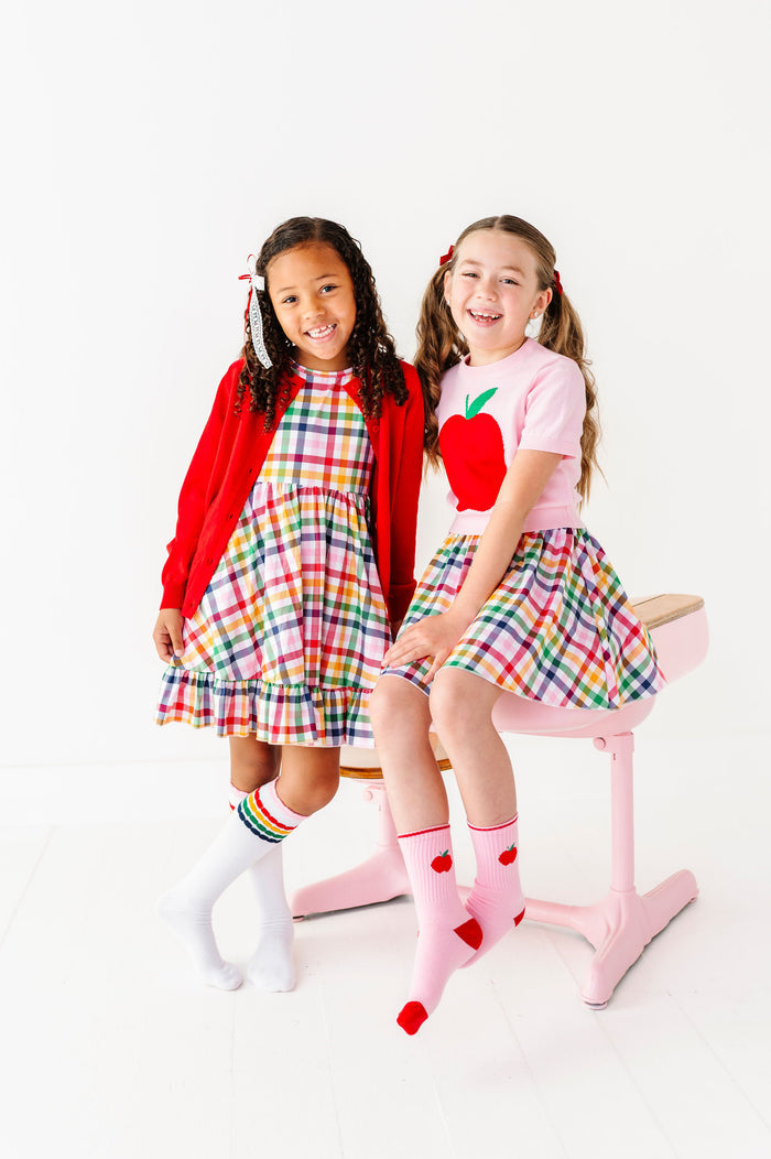 Girls wearing matching back to school outfits with primary colors