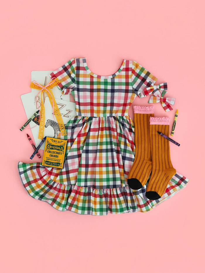 girls gingham twirl dress in primary colors paired with pencil inspired bow and socks