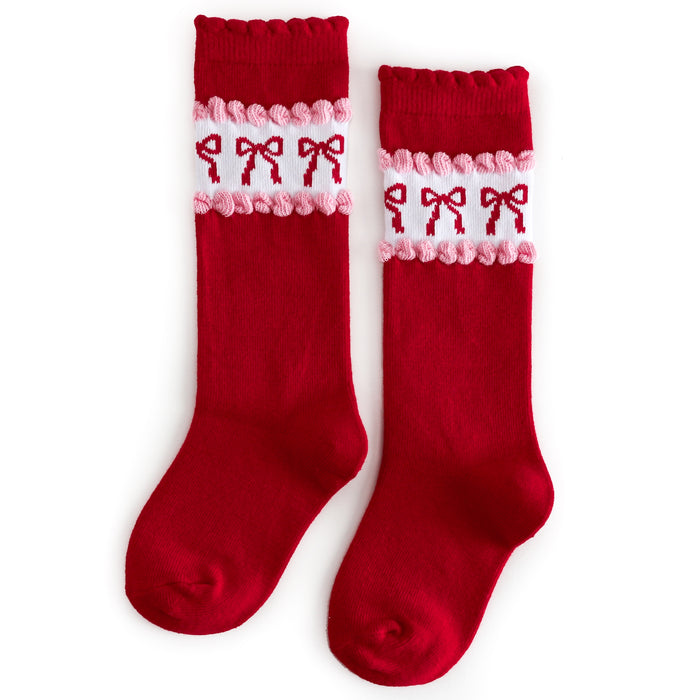 girls red knee-high socks with scalloped trim and vintage wallpaper inspired white, pink and red bow design at the calf