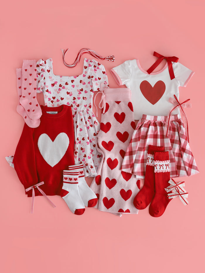 girls red and pink themed valentines flat lay with mix and match outfits and accessories featuring hearts
