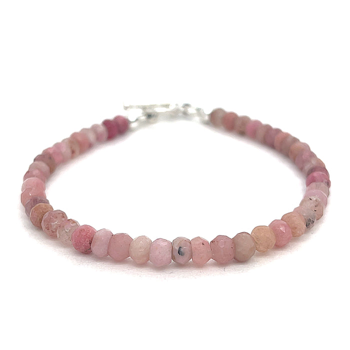 A Rhodochrosite Gemstone 3mm faceted roundel beaded bracelet with a sterling silver toggle, on a white background, front overview.