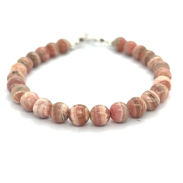 A Rhodochrosite Gemstone 6mm roundel beaded bracelet with a sterling silver toggle, on a white background, front close up overview.
