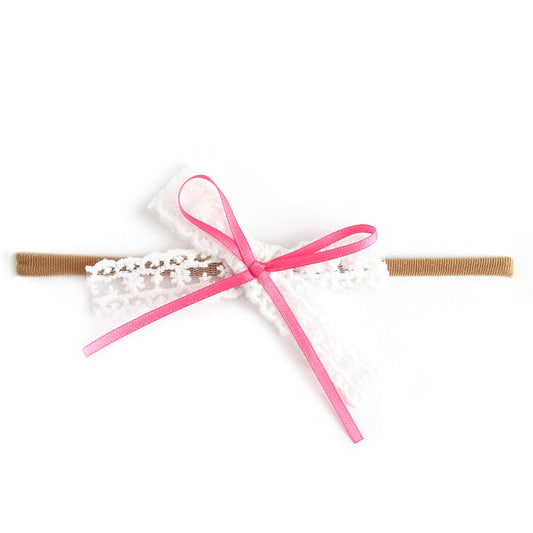 baby girls' white lace bow with pink satin ribbon detail on nylon