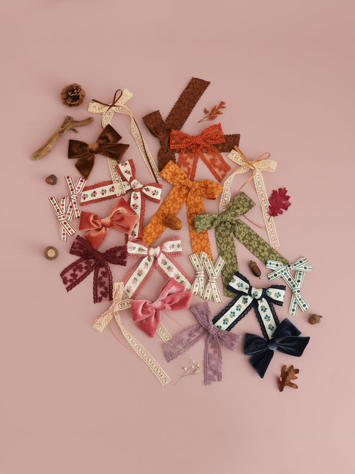 assortment of girls' hair bows on clips in fall shades to match fall apparel