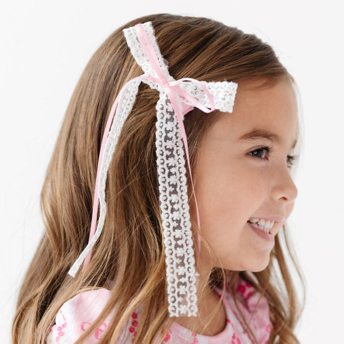 little girl in double white lace and pink satin hairbow and matching pink bow wallpaper print twirl dress for spring and easter