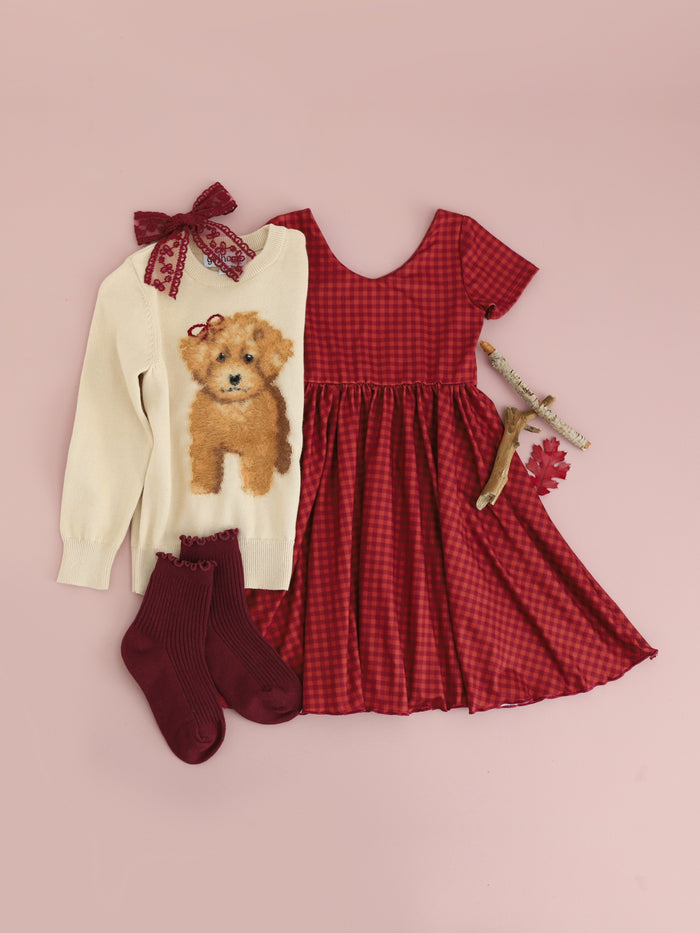 girls' rust gingham v-neck twirl dress paired with cream sweater with fluffy puppy design and matching burgundy accessories