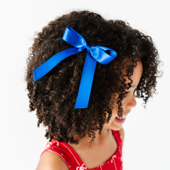 little girl in red tank twirl paired with royal blue satin hair bow on clip