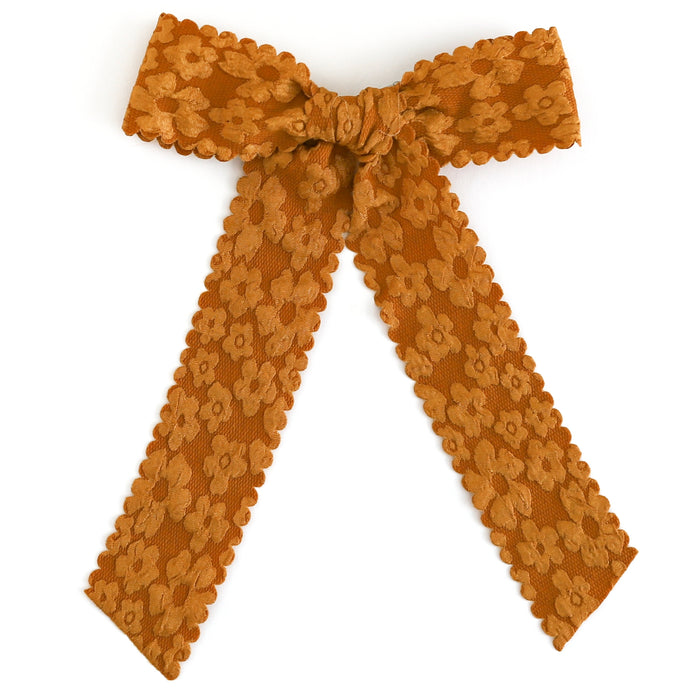 girls mustard ribbon bow with flower pattern and scalloped trim on alligator clip