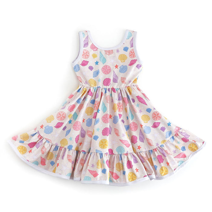 girls' beach themed sleeveless twirl dress with colorful seashell print on cream background with white binding