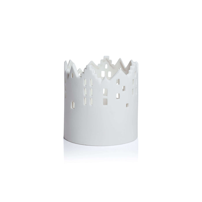 White decorative candle holder with cut-out design on a white background